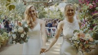 two brides holding hands after the wedding ceremony at holly farm