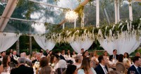 tented wedding reception with beautiful floral installation