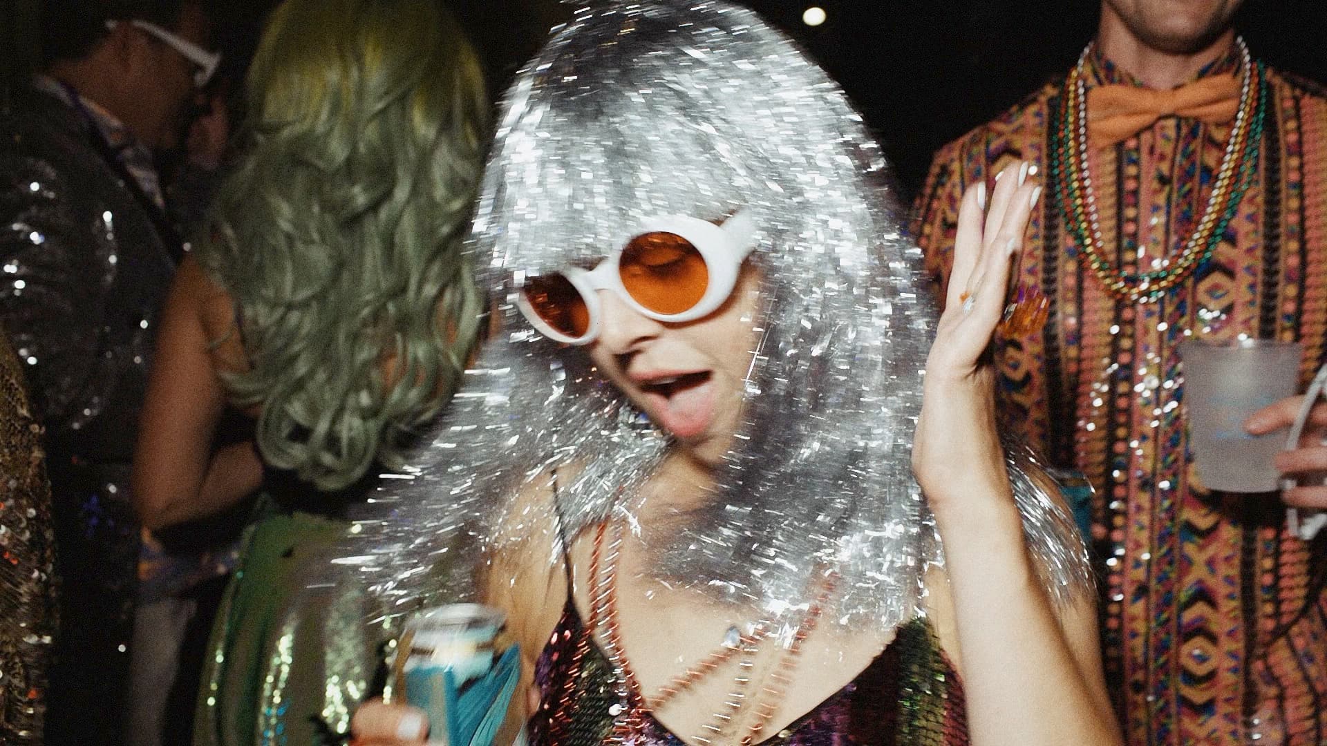 wedding guest wearing mardi gras inspired silver wig