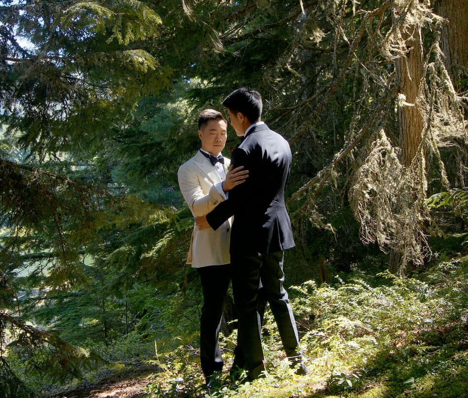 gay wedding couple hugging in the forest in whistler