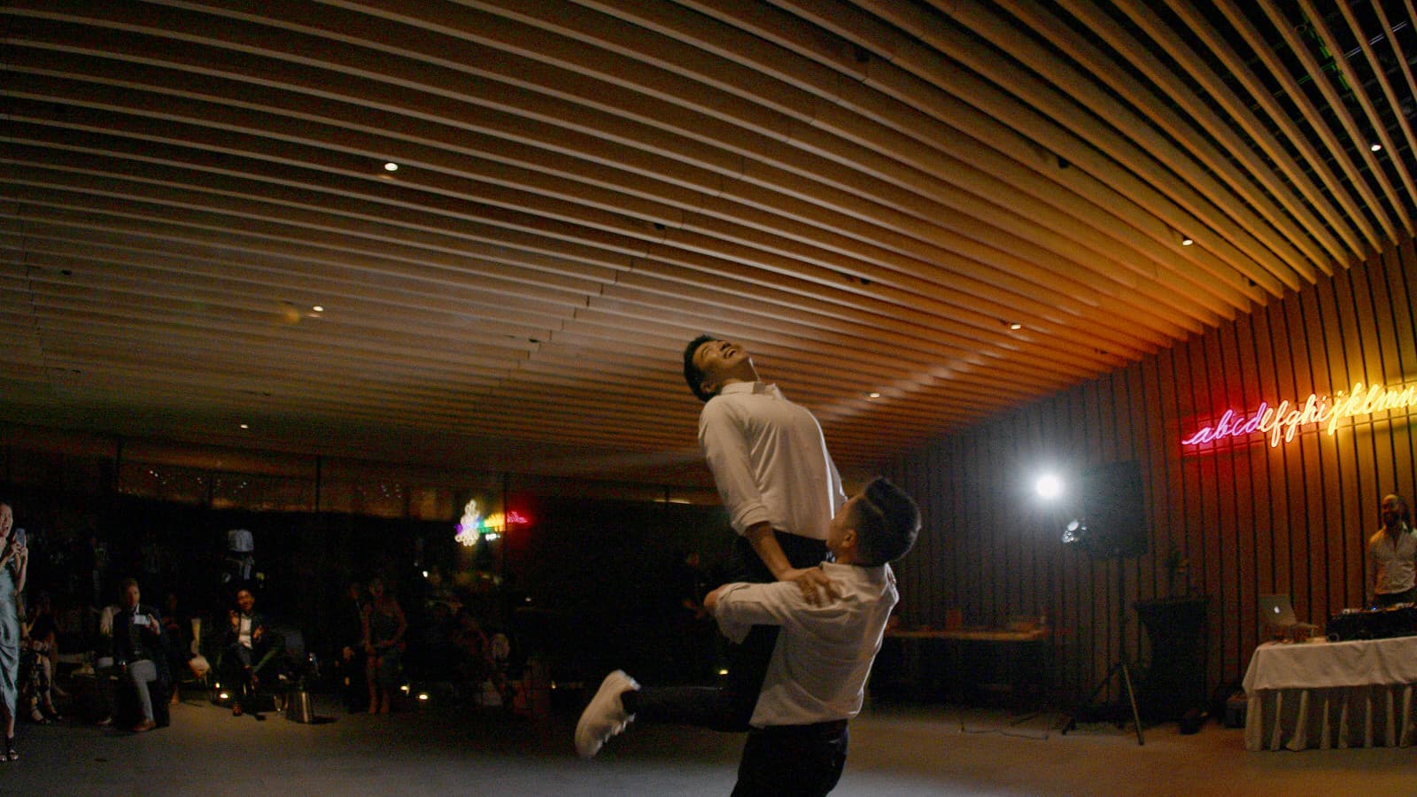 gay wedding couple dancing inside the audain art museum