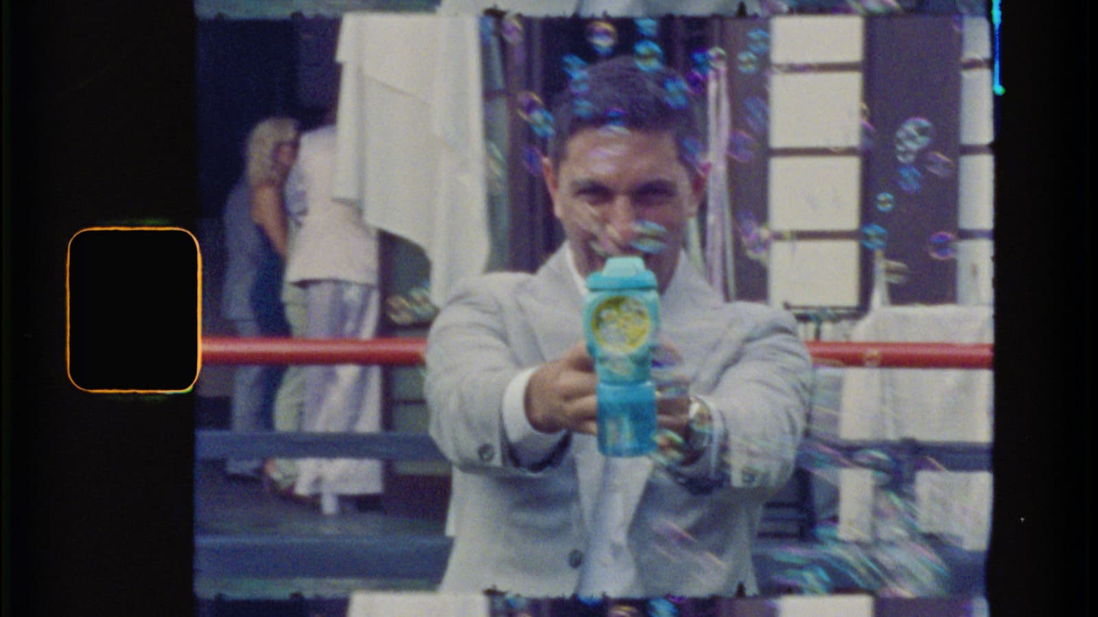 groom shooting bubble gun at the camera
