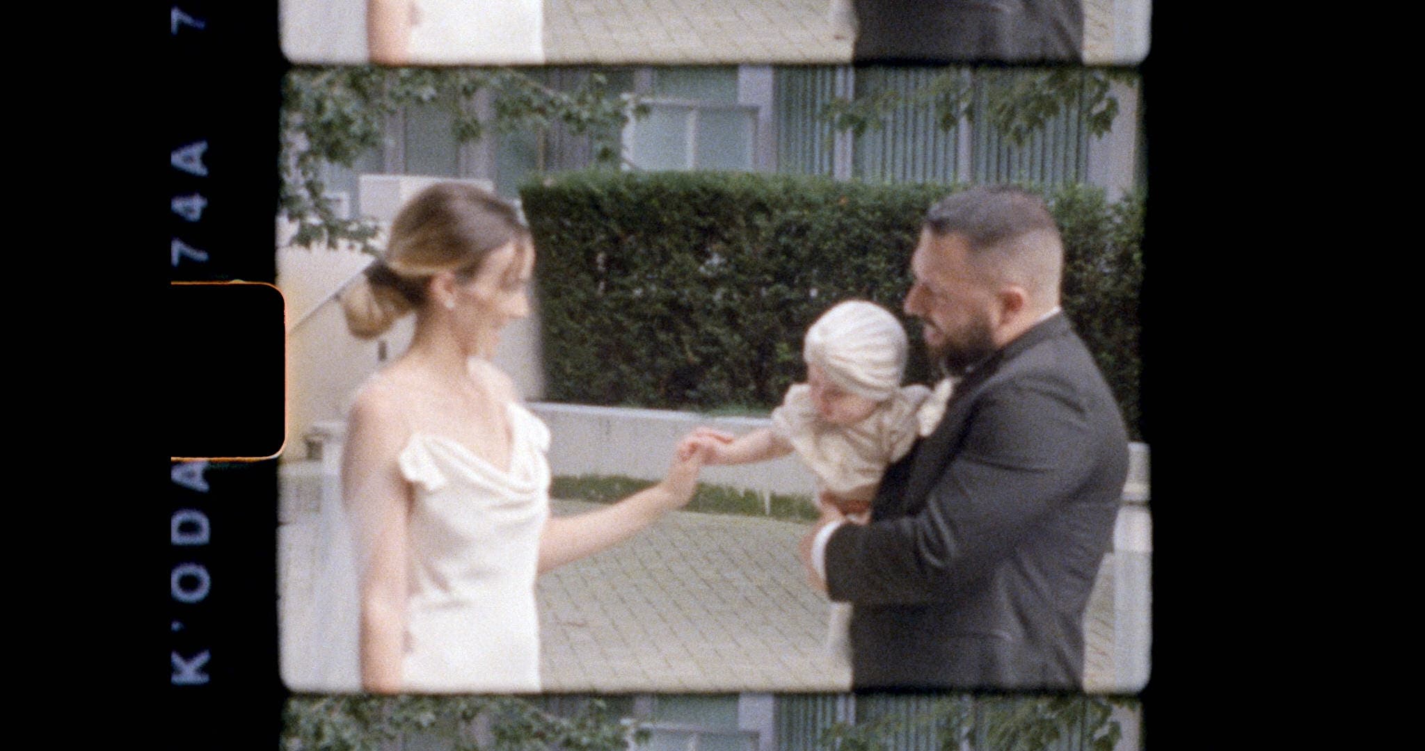 super 8mm film still of married couple and baby